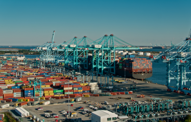Cars, cargo containers, and cranes at port